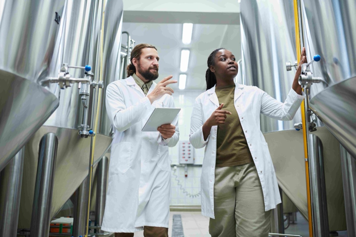 Engineers checking equipment in a production facility